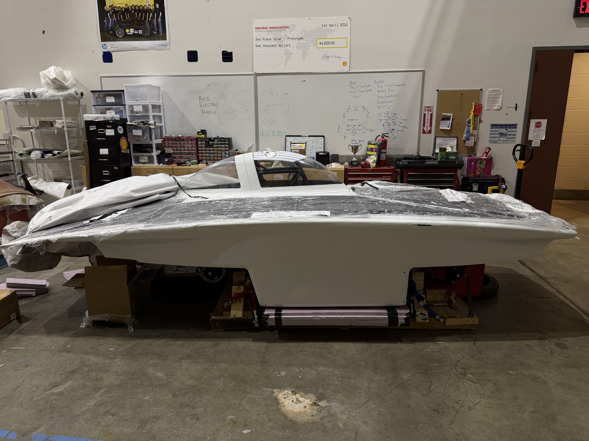Side profile of the Carrera solar car in the workshop