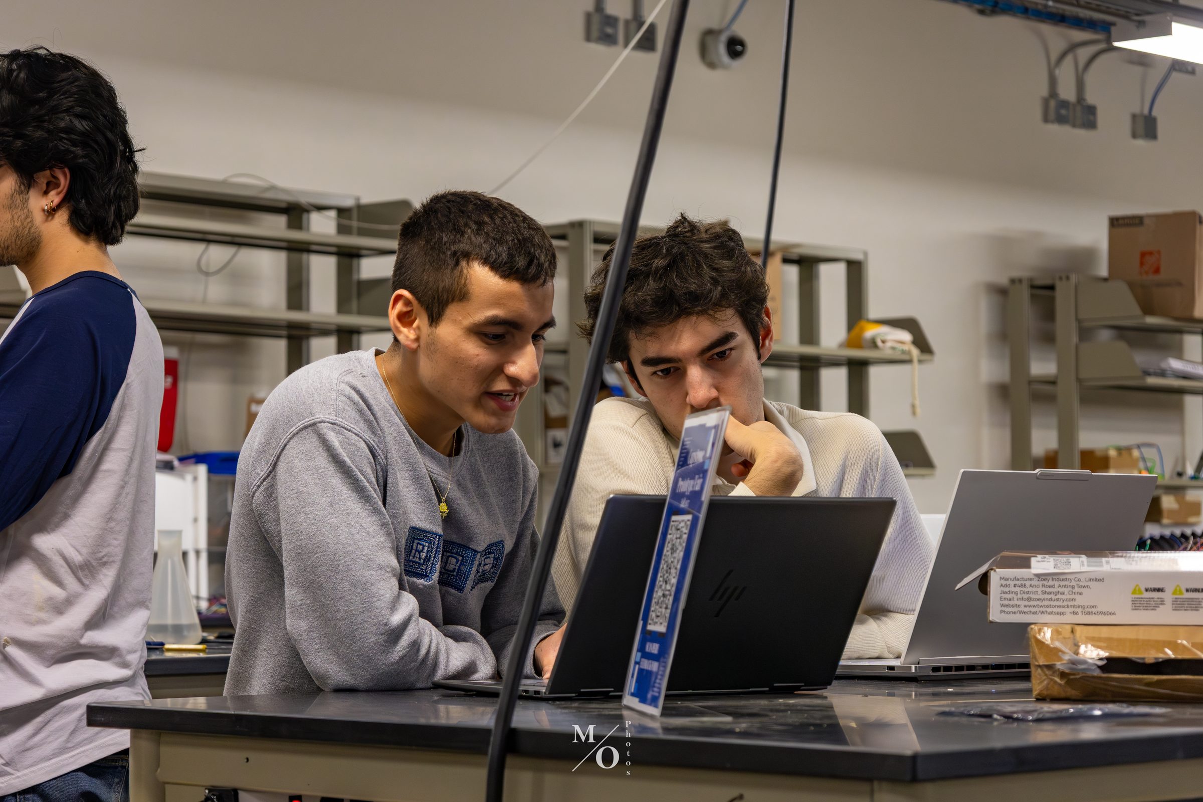 Two team members reviewing data on a laptop