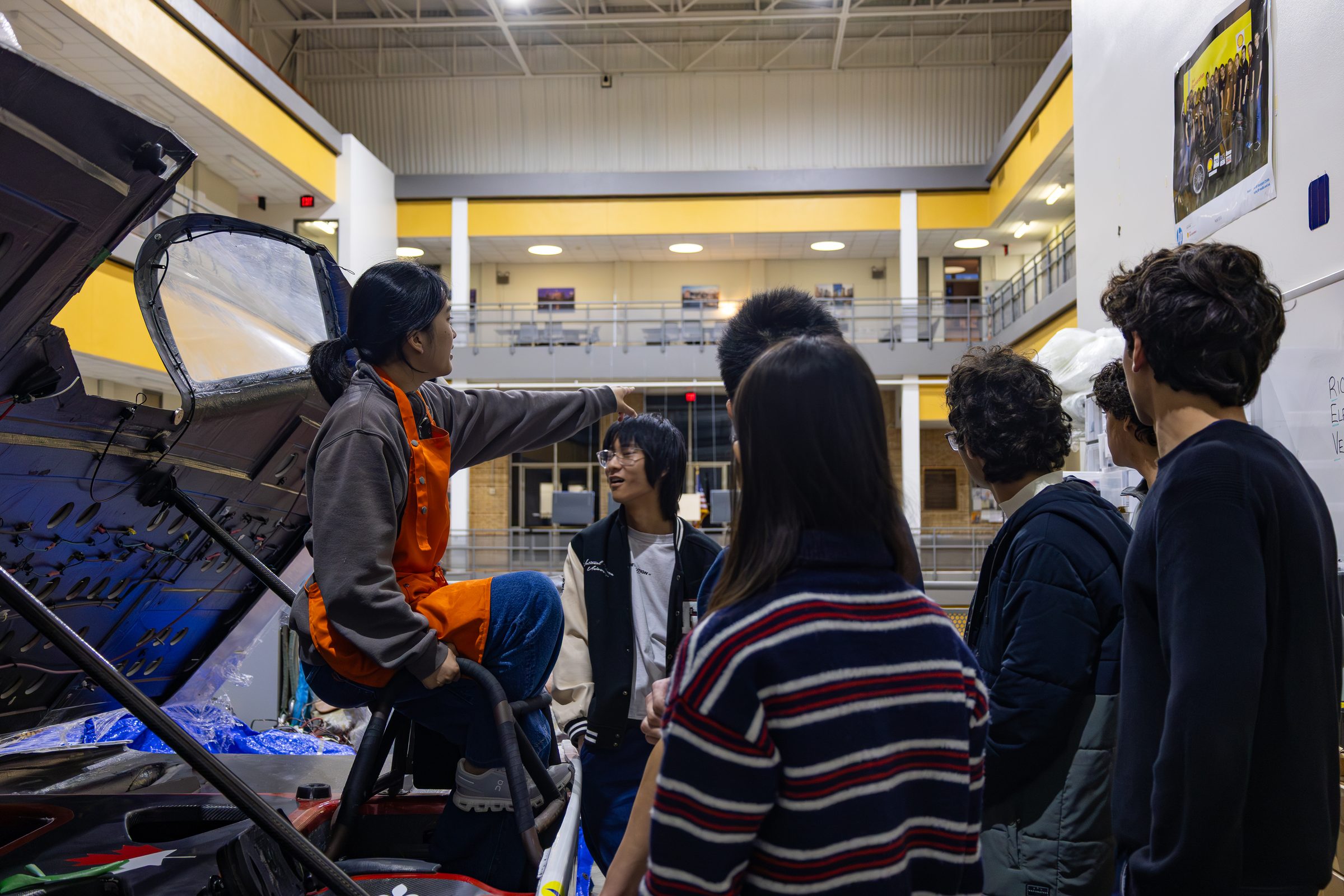 A team member presenting the car to a small group of visitors