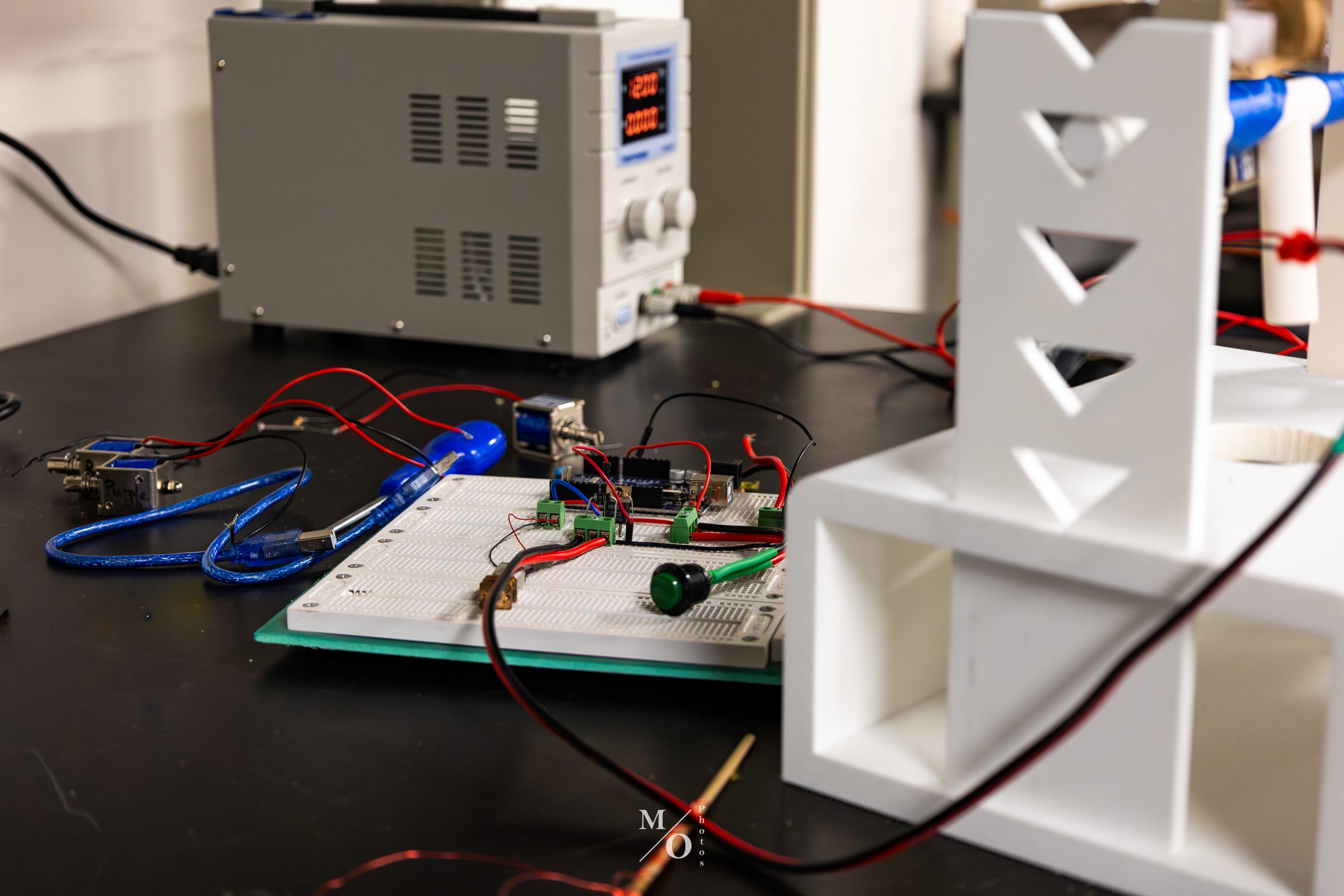 Electronics workbench with a breadboard, power supply, and prototyping hardware